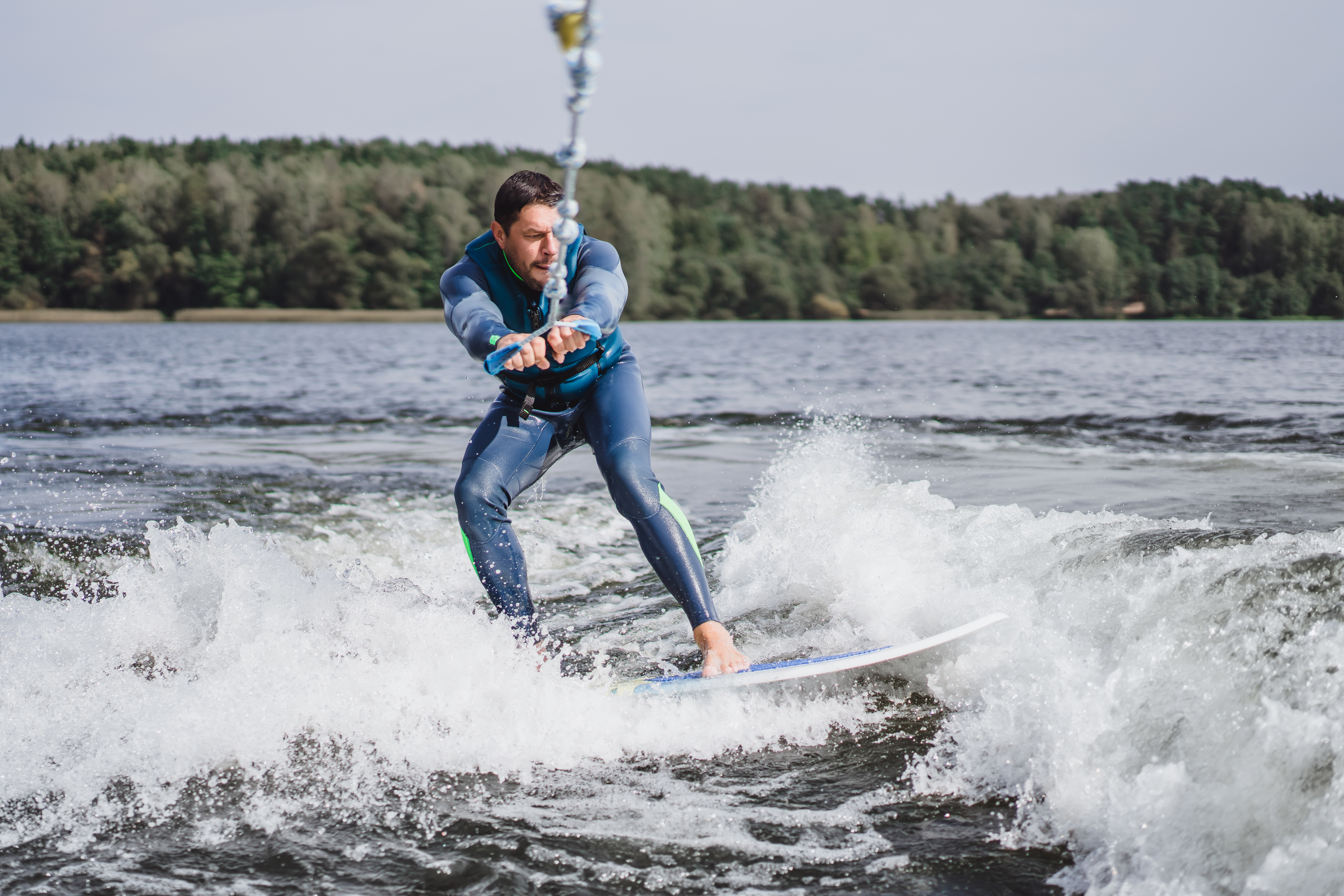 man-wakesurfing-wave-from-boat.jpg